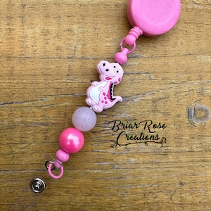 Pink Dinosaur Badge Reel