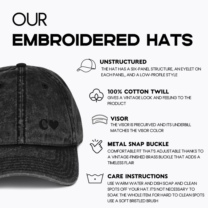 May include: A black distressed baseball cap with a white heart and the letter C embroidered on the front. The cap is unstructured, made of 100% cotton twill, and has a precurved visor. It features a metal snap buckle for adjustability.