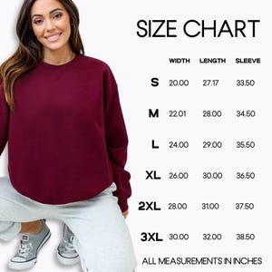 May include: A burgundy sweatshirt with a size chart. The chart displays measurements in inches for width, length, and sleeve length for sizes S to 3XL. The text "SIZE CHART" is at the top.