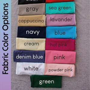 K&ouml;nnte beinhalten: Stoffmuster in verschiedenen Farben, darunter Schwarz, Rot, Grau, Seegr&uuml;n, Cappuccino, Lavendel, Marine, Blau, Creme, Pink, Jeansblau, Rosa, Wei&szlig;, Puderrosa und Gr&uuml;n. Die Muster sind in zwei Spalten angeordnet, mit dem Text "Fabric Color Options" auf der linken Seite des Bildes.