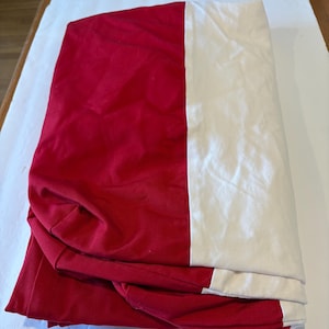 Futon Cushion/Mattress Cover. White W/Red Border. Length 72”. Width 45”. Depth 5” W/ Addional Stretch. Zip Closure.
