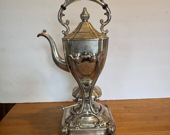 Tetera basculante vintage Goldfeder plateada con soporte y quemador.