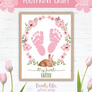 May include: A framed print with the text "FOOTPRINT CRAFT" and "My first EASTER". The artwork features pink footprints, a floral wreath, and a brown bunny. The words "INSTANT DIGITAL DOWNLOAD" are also visible.