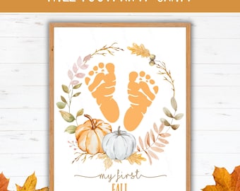 May include: A framed print with the text "FALL FOOTPRINT CRAFT." The artwork features orange footprints, pumpkins, and fall foliage. The words "my first FALL" are written below the pumpkins.