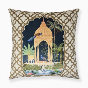 May include: A decorative throw pillow with a gold and white geometric pattern. The center of the pillow features a dark blue background with a gold and orange pagoda, palm trees, and peacocks.
