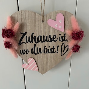 Wooden heart with the inscription "Home is where you are." Spring heart, decorative heart, flower heart, dried flowers and artificial flowers.
