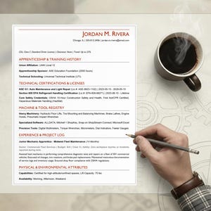 May include: A resume with the name "JORDAN M. RIVERA" and contact details is displayed on a light surface. A cup of coffee sits to the right, and a hand holding a pencil is at the bottom. The resume lists skills and experience.