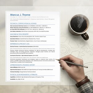 May include: A resume with the name "Marcus J. Thorne" and a cup of coffee. A hand with a pencil is poised over the resume. The resume lists technical certifications, machine and tool registry, experience, and apprenticeship history.