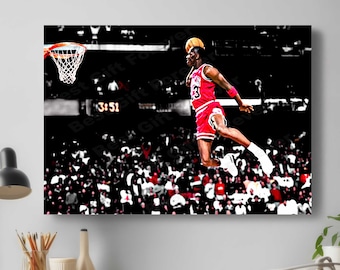 May include: A black and white photo of a basketball player in mid-air, about to dunk the ball. The player is wearing a red and white jersey with the number 23 on it. The player is surrounded by a crowd of people.