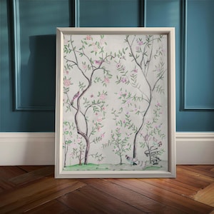 One of the listing’s antique chinoiserie prints of wispy trees with green leaves and pastel-colored blossoms hosting various colorful birds and a butterfly against an off-white background sits in a simple white frame on a vintage wood floor against a muted blue-colored wall.