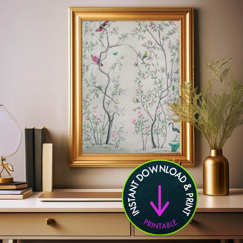 One of the listing’s antique chinoiserie prints of wispy trees with green leaves and pastel-colored blossoms hosting various colorful birds and a butterfly against an off-white background hangs in a gold frame above a desk. On the desk, a gold vase holding greenery, a stack of books and a retro lamp. A Scavenger Hunt Art graphic reads, 'INSTANT DOWNLOAD & PRINT.'