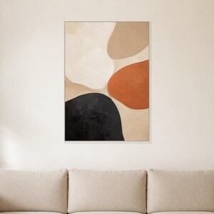 May include: A rectangular wall art piece featuring an abstract composition of organic, rounded shapes in shades of cream, beige, terracotta orange, and black. The surface displays a visible, textured paint application within a thin frame.
