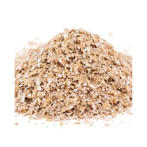 May include: A close-up of a pile of light brown wheat bran flakes.