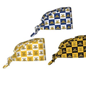 May include: Three scrub caps featuring a checkered pattern with a repeating bear graphic and the text "BEARS" printed on each square. The caps are available in blue and white, yellow and white, and black and yellow color combinations with ties.