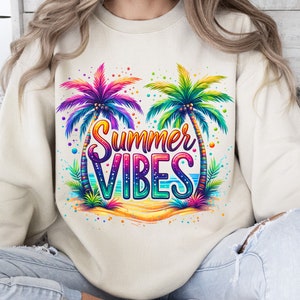 Peut inclure: Un sweat-shirt cr&egrave;me avec un motif color&eacute; de deux palmiers et le texte "Summer Vibes".