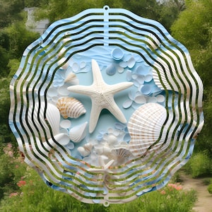 May include: A white metal wind spinner with a blue and white seashell design. The spinner features a starfish, seashells, and other ocean-themed elements.