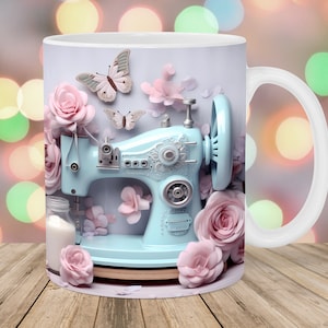May include: A white ceramic mug with a light blue sewing machine design, pink roses, and butterflies. The mug has a white handle. The design is set against a blurred background with bokeh lights.