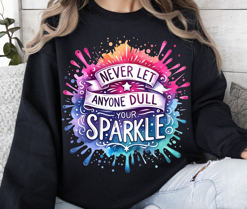 May include: Black sweatshirt with a colourful watercolour design that says "Never let anyone dull your sparkle."