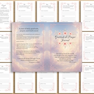 May include: A Gratitude & Prayer Journal with a floral design and the text "Gratitude & Prayer Journal." The journal includes daily prompts and Bible verses. The pages have a soft pink floral border and are arranged on a wooden surface.