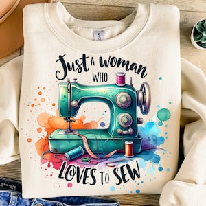 May include: A beige sweatshirt with a watercolor design of a sewing machine and the text "Just a woman who loves to sew".