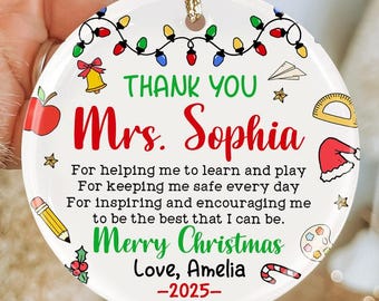 May include: A white ceramic Christmas ornament with the text "THANK YOU Mrs. Sophia" in green and red. The ornament includes the message "Merry Christmas Love, Amelia -2025-" and festive illustrations.