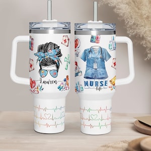 May include: White travel mug with a handle and a straw. One side features a nurse design with the name "Lauren", and the other side has a nurse uniform and the words "NURSE life". The bottom has a colorful heartbeat design.