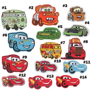 May include: A selection of embroidered car patches in various colours. Designs include cartoon cars, trucks, and vans with smiling faces. Some patches feature the number "95" or the word "Turbo".