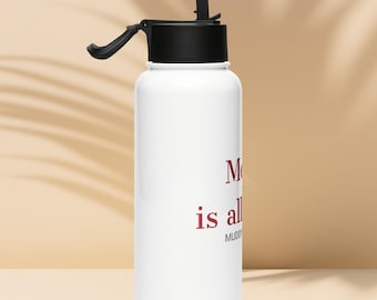 May include: A white stainless steel water bottle with a black lid and a flip-up straw. The bottle features red text that reads "Me is all" and smaller gray text below it that reads "MUDDY". The design is printed on the front of the bottle.