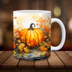 May include: White ceramic mug with a watercolor design of a large orange pumpkin surrounded by fall leaves. The pumpkin is sitting in a pool of water with reflections of the leaves.