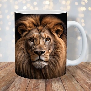 May include: White ceramic mug with a close-up image of a lion's face. The lion has a thick mane of brown and gold fur.