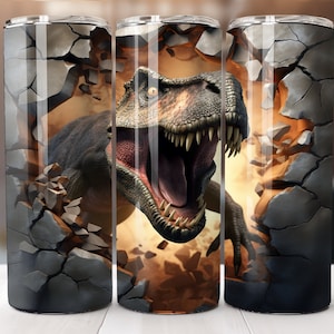 May include: Three stainless steel tumblers with a graphic of a dinosaur breaking through a cracked wall. The dinosaur is green, brown, and gray with a large open mouth. The wall is gray and brown.
