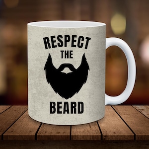 May include: White ceramic mug with a black silhouette of a beard and the text "Respect the beard".