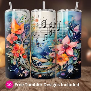May include: Three stainless steel tumblers with a watercolor design of flowers, musical notes, and a butterfly. The tumblers are on a wooden surface.