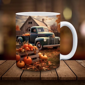 May include: White ceramic mug featuring a fall scene with a vintage teal truck filled with pumpkins. The background includes a barn, autumn leaves, and more pumpkins, evoking a harvest theme.