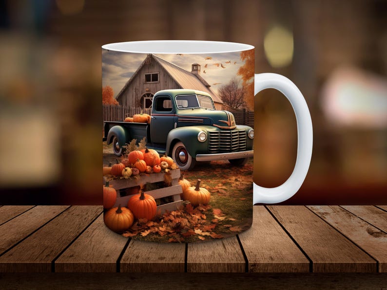 May include: White ceramic mug featuring a fall scene with a vintage teal truck filled with pumpkins. The background includes a barn, autumn leaves, and more pumpkins, evoking a harvest theme.