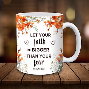 May include: White ceramic mug with a floral design in orange and green. The mug features the text "LET YOUR faith BE BIGGER THAN YOUR fear" with two heart symbols. The text "PSALMS 27:1" is also included.