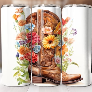 May include: A white tumbler with a brown cowboy boot design. The boot is surrounded by colorful flowers, including sunflowers, red roses, and orange lilies.