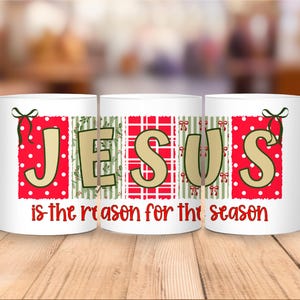 May include: White ceramic mug with the word "JESUS" in a festive design. The letters are set against red polka dots, green stripes, and a red plaid pattern. The phrase "is the reason for the season" is printed below.