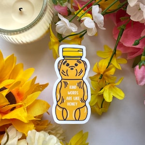 May include: A yellow honey bear sticker with the text "Kind words are like honey".