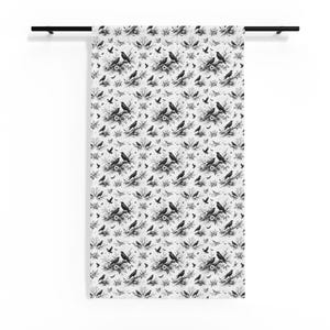 May include: A white and black patterned curtain featuring a repeating design of crows perched on branches and floral elements. The design includes smaller birds and floral accents, creating a gothic or vintage aesthetic.