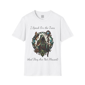 May include: White t-shirt with a graphic of a hooded figure holding a staff with a blue gem at the top. The figure is surrounded by green leaves and vines. The text "I Speak For the Trees (And They Are Not Pleased)" is printed on the shirt.
