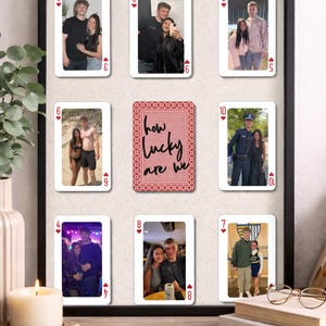 May include: A framed collage featuring playing cards with personal photos. The central card reads "how lucky are we." The other cards display various photos of couples. The frame is black, and the overall aesthetic is sentimental and personalized.