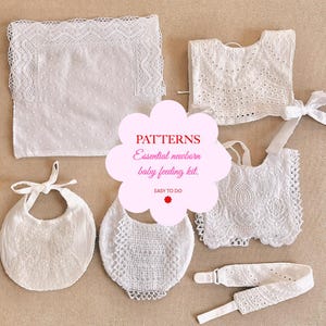 May include: A set of white crocheted baby bibs, burp cloths, and a headband. The items are laid out on a beige surface. The text "PATTERNS Essential newborn baby feeding kit. EASY TO DO" is written in a pink cloud shape.