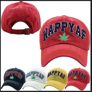 May include: Five different colored baseball caps with the text "Happy AF" embroidered on the front. Each cap has a green marijuana leaf embroidered below the text. The caps are red, black, white, yellow, and red.
