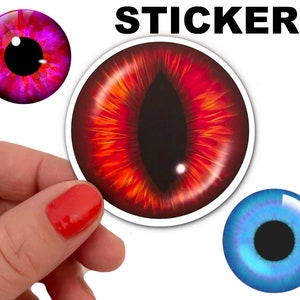 May include: Three eye stickers with different colors and designs. The stickers are round and feature a realistic eye with a black pupil and a colored iris. The first sticker has a pink iris with a red outer ring, the second sticker has a red iris with an orange outer ring, and the third sticker has a blue iris with a purple outer ring.