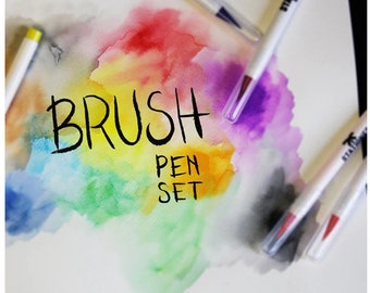 May include: A set of brush pens with a rainbow watercolor background. The text "BRUSH PEN SET" is written in black marker.