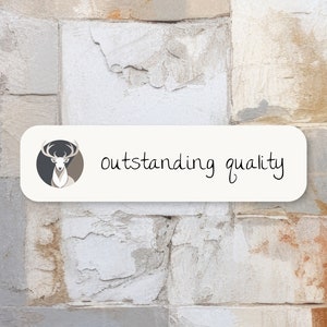 May include: A white rectangular sign with rounded corners features a stylized deer head illustration in a circle on the left side and the text "outstanding quality" in black handwritten font on the right side.