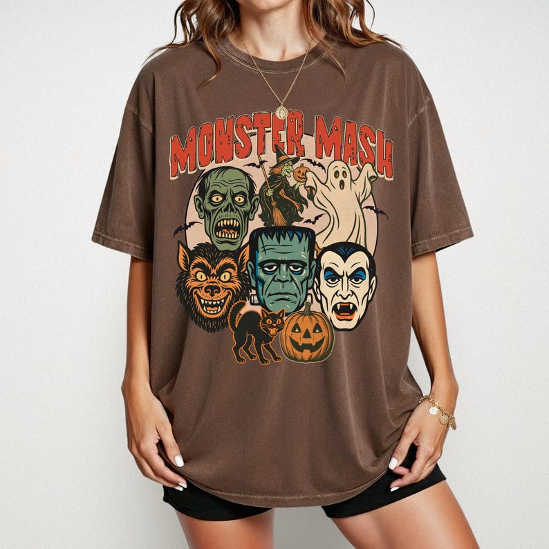 Espresso Comfort Colors Monster Mash Halloween shirt with Frankenstein, Dracula, ghost, witch, and pumpkin retro horror design on a cinnamon-colored oversized tee.