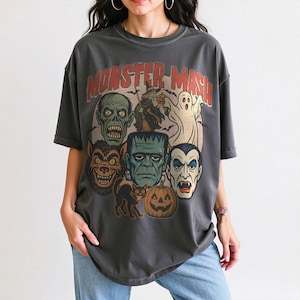 Pepper Comfort Colors Monster Mash Halloween shirt with Frankenstein, Dracula, ghost, witch, and pumpkin retro horror design on a cinnamon-colored oversized tee.
