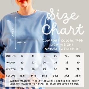 May include: A light blue unisex sweatshirt with a size chart. The chart displays measurements in inches for width, length, and sleeve length, ranging from size small to 3XL. The text "COMFORT COLORS 1466 LIGHTWEIGHT UNISEX SWEATSHIRT" is also visible.